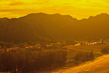 Image showing  fishing villages near mountain and sunset