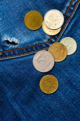 Image showing jeans pocket with hole and coins