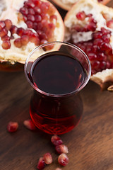 Image showing Ripe pomegranates with juice on table