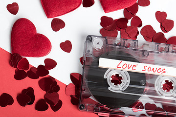 Image showing Audio cassette tape on red backgound with fabric heart