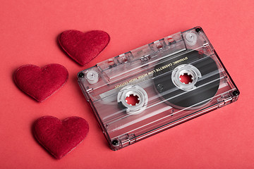 Image showing Audio cassette tape on red backgound with fabric heart