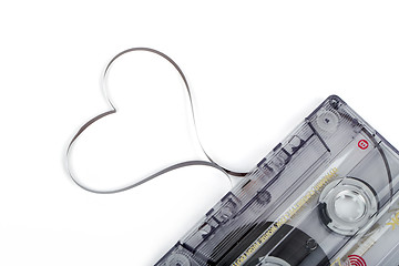 Image showing Audio cassette tape on white backgound. Film shaping heart