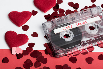 Image showing Audio cassette tape on red backgound with fabric heart