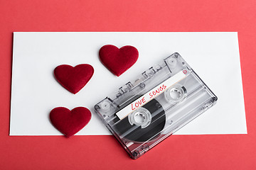 Image showing Audio cassette tape on red backgound with fabric heart