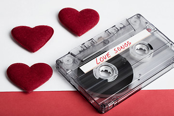 Image showing Audio cassette tape on red backgound with fabric heart