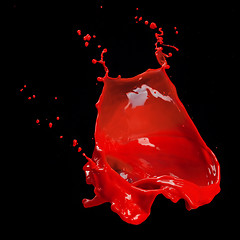 Image showing splash of red paint isolated on black