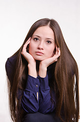 Image showing Beautiful girl rests her chin on hand