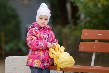 Image showing Upset girl in autumn clothes shops costs about