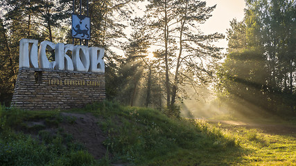 Image showing Sunset light in forest near Pskov city sign 