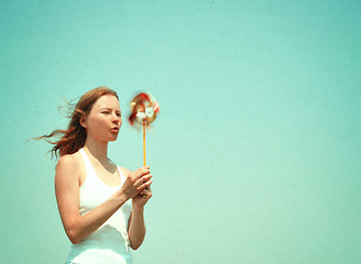 Image showing Young woman with a colorful pinwheel