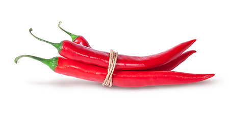 Image showing Three red chili peppers tied with a rope