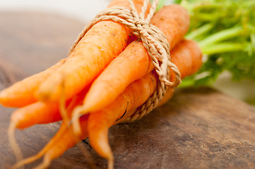 Image showing baby carrots bunch tied with rope