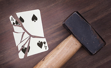 Image showing Hammer with a broken card, four of spades