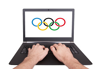 Image showing Man working on laptop, olympic rings