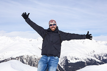 Image showing Guy is happy to be in the snowy mountains