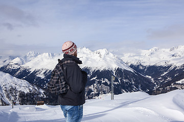 Image showing Young man enjoys the view in the mountains