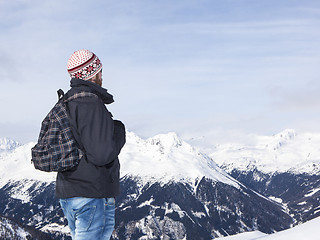 Image showing Young man enjoys the view in the mountains