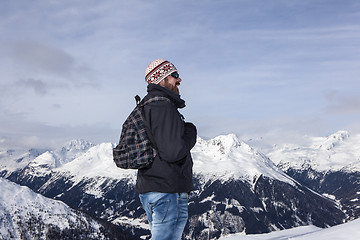 Image showing Young man enjoys the view in the mountains