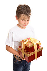 Image showing Child holding stack of presents