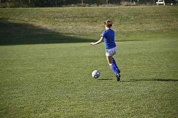 Image showing Girl Dribbling a Soccer Ball Before a Match