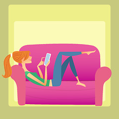Image showing The girl lies on the sofa and reads a smartphone