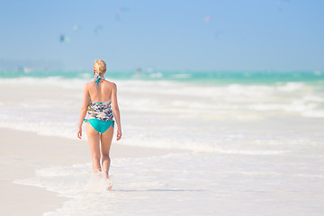 Image showing Woman running on the beach in sunset.