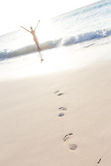 Image showing Woman running on the beach in sunset.