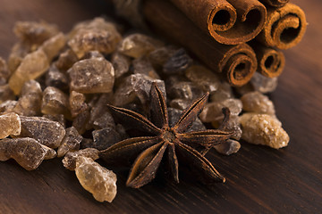 Image showing Cinnamon sticks with pure cane brown sugar on wood background