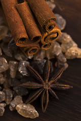 Image showing Cinnamon sticks with pure cane brown sugar on wood background