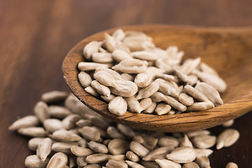 Image showing Sunflower seed with a wooden spoon