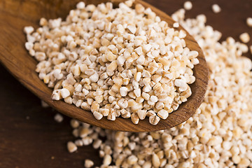 Image showing Barley groats on wooden spoon