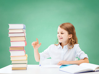 Image showing happy girl with books and notebook at school