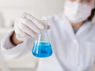 Image showing close up of woman with flask making test in lab