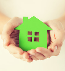 Image showing woman hands holding green house