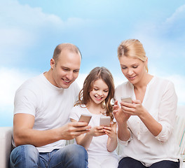 Image showing happy family with smartphones