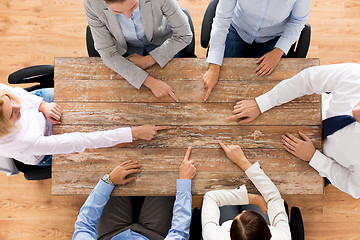 Image showing close up of business team sitting at table