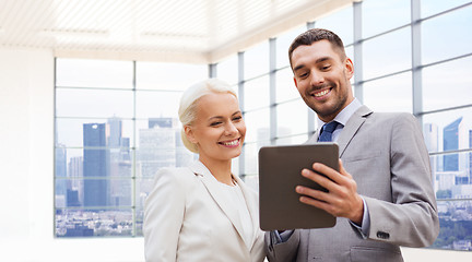 Image showing smiling businessmen with tablet pc outdoors