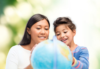 Image showing mother and daughter with globe