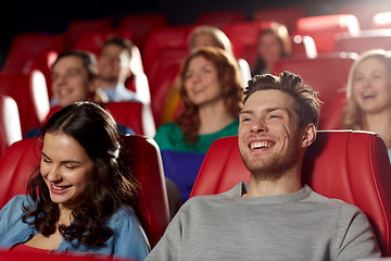 Image showing happy friends watching movie in theater