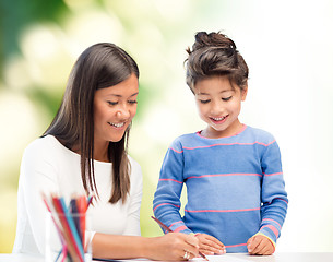 Image showing happy mother and daughter drawing with pencils