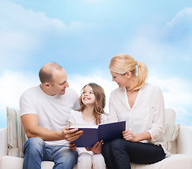 Image showing happy family with book at home