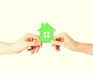 Image showing couple hands holding green house