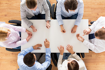 Image showing close up of business team sitting at table