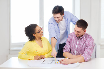 Image showing three smiling architects working in office
