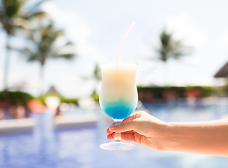 Image showing close-up of hand holding glass with cocktail