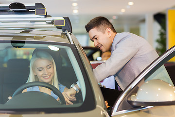 Image showing happy woman with car dealer in auto show or salon