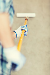 Image showing man colouring the wall with roller