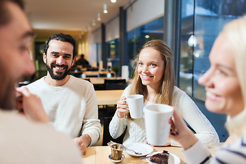 Image showing happy friends meeting and drinking tea or coffee