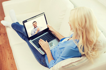 Image showing smiling woman with laptop computer at home