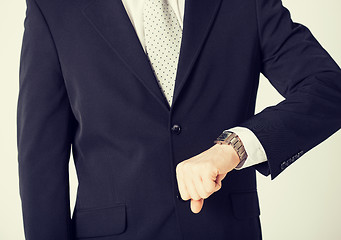 Image showing man looking at wristwatch